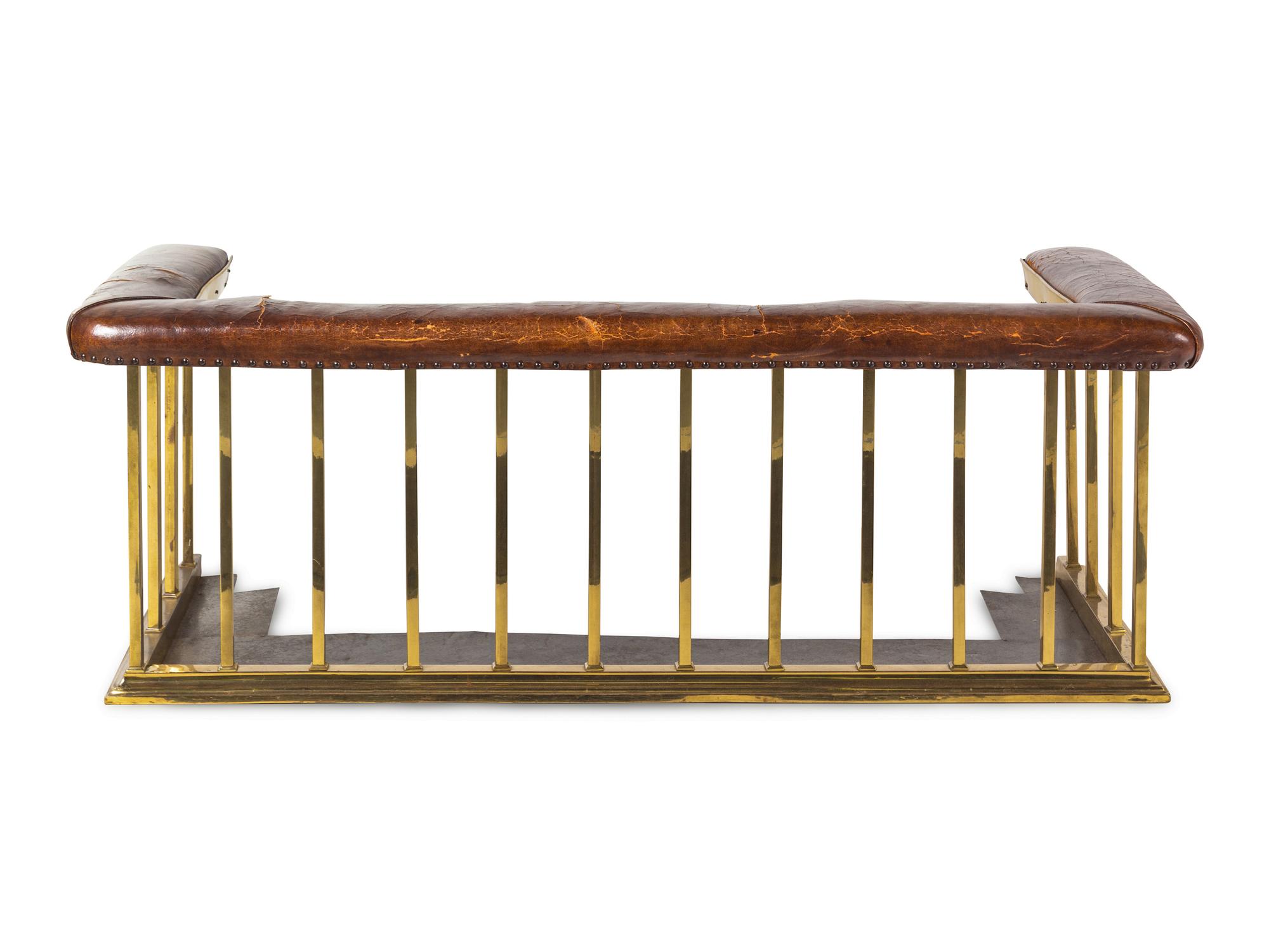 An English Leather-Upholstered Brass Club Fender
