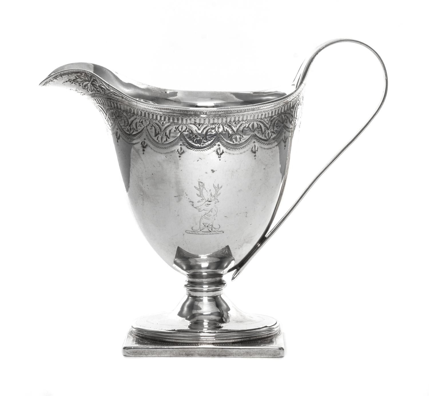 A George III Silver Creamer, John Schofield, London, 1790, having a bright cut foliate swag border at the upper rim, one side engraved