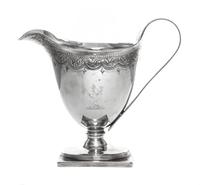 A George III Silver Creamer, John Schofield, London, 1790, having a bright cut foliate swag border at the upper rim, one side engraved