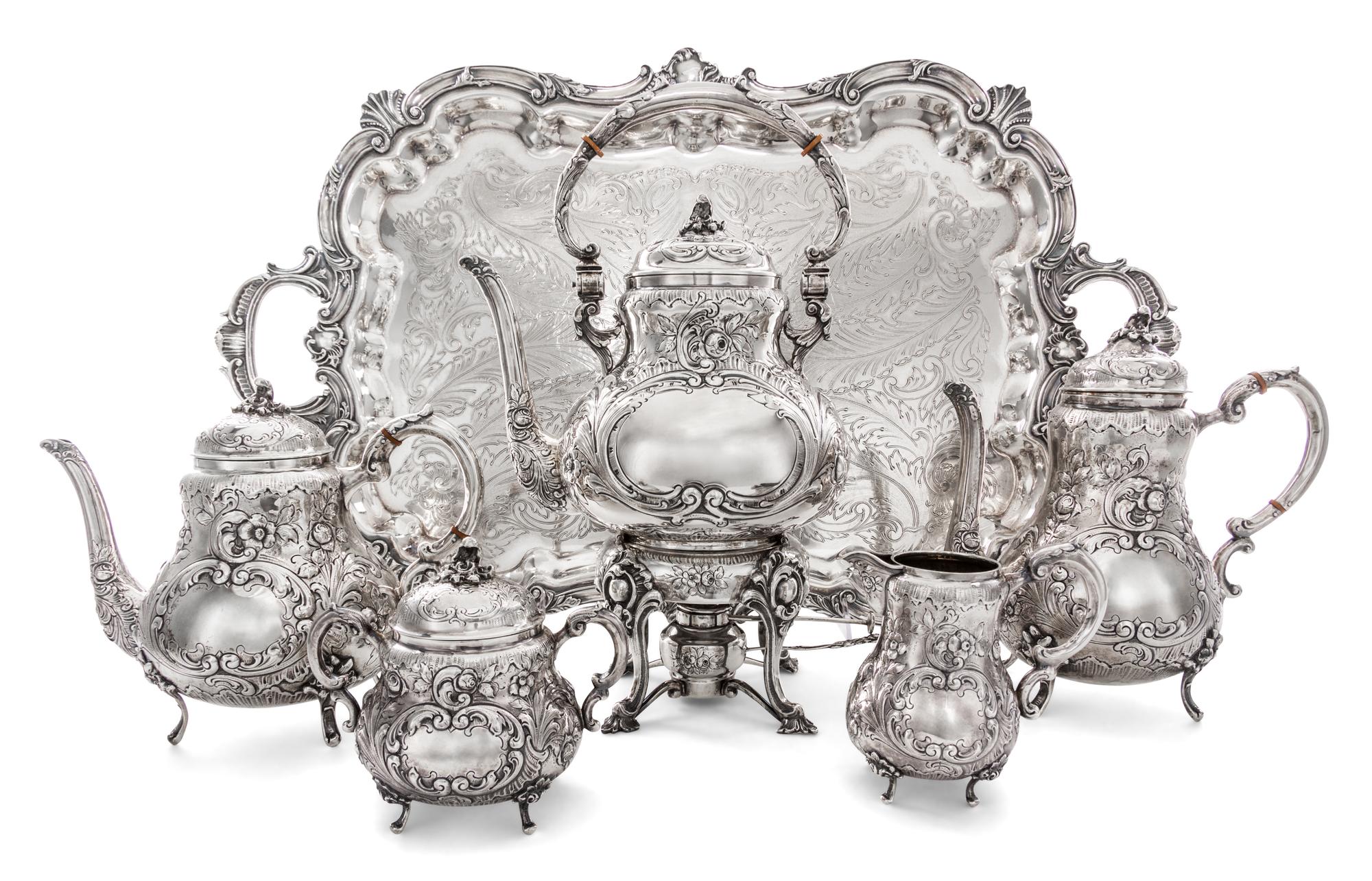 An American Silver Five-Piece Tea and Coffee Service, 19th/20th Century, each with allover foliate repousse decoration, comprising a ke