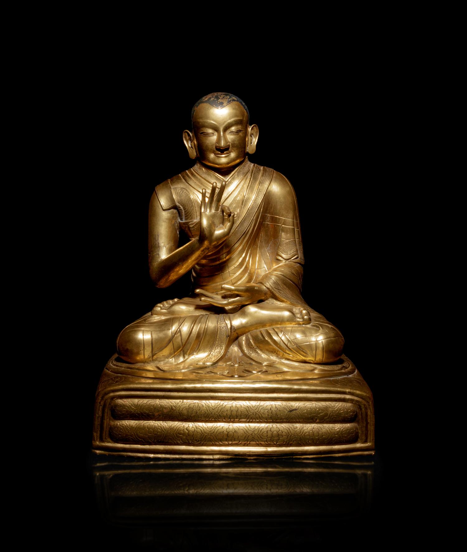 A Large Sino-Tibetan Gilt Copper Repoussé Figure of a Seated Lama