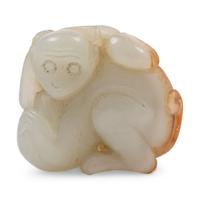 A Celadon and Russet Jade Figure of a Monkey