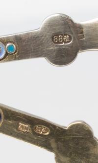 Two Russian Silver-Gilt and Enamel Tea Strainers, Marks likely of Antip Kuzmichev, Moscow, late 19th century, each with a flared handle