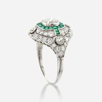 A diamond, emerald, and platinum ring