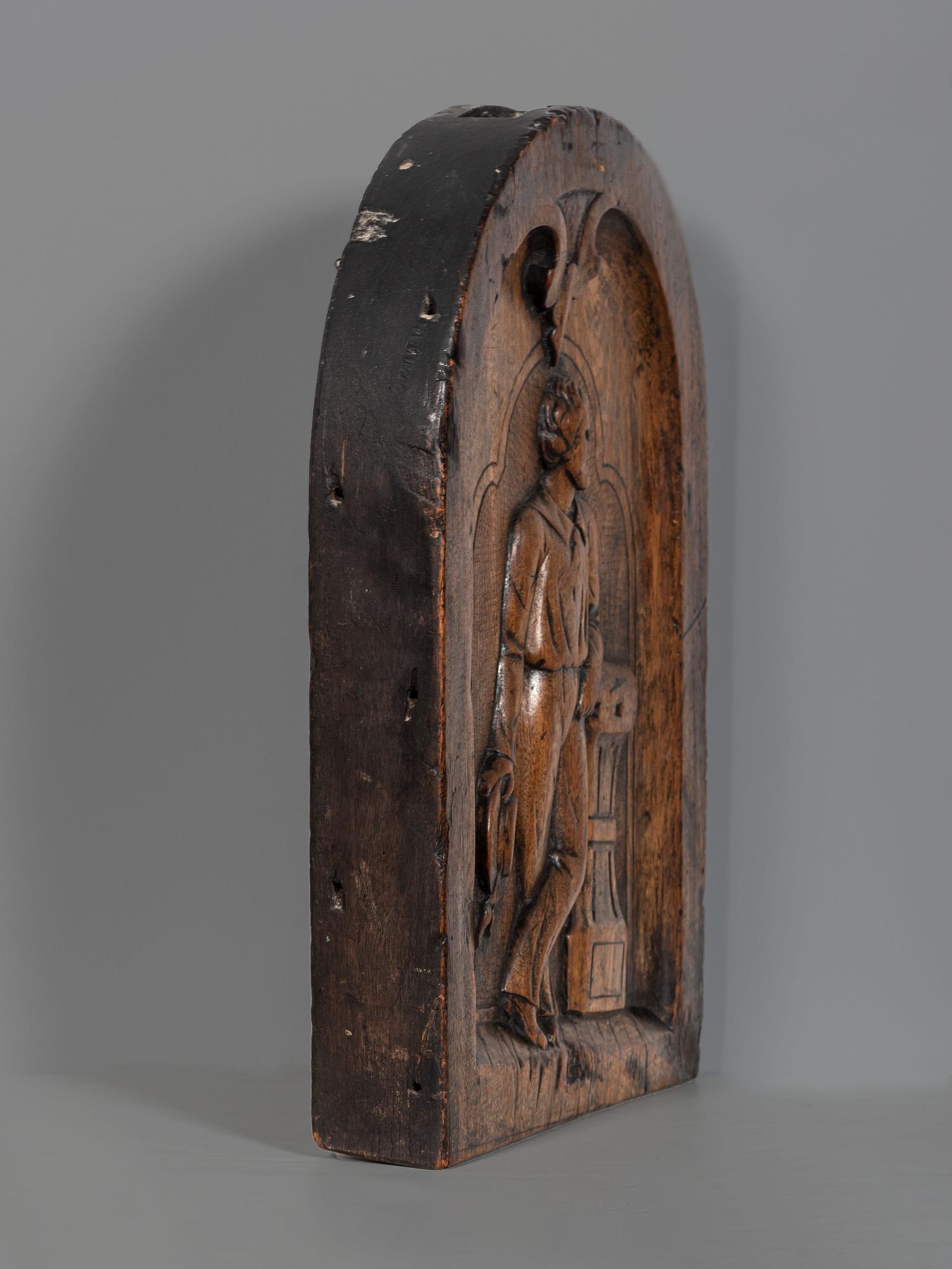 A Carved Walnut Ship Board Panel of a Sailor