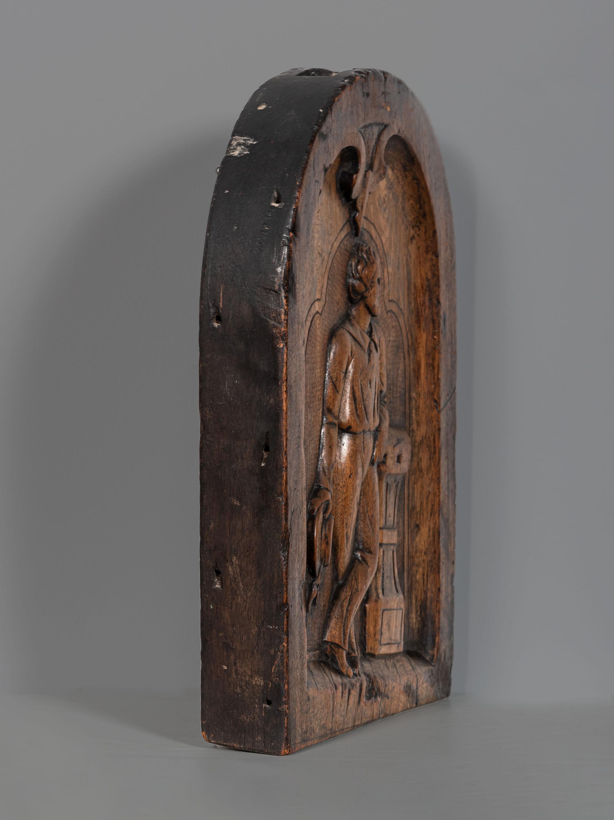 A Carved Walnut Ship Board Panel of a Sailor