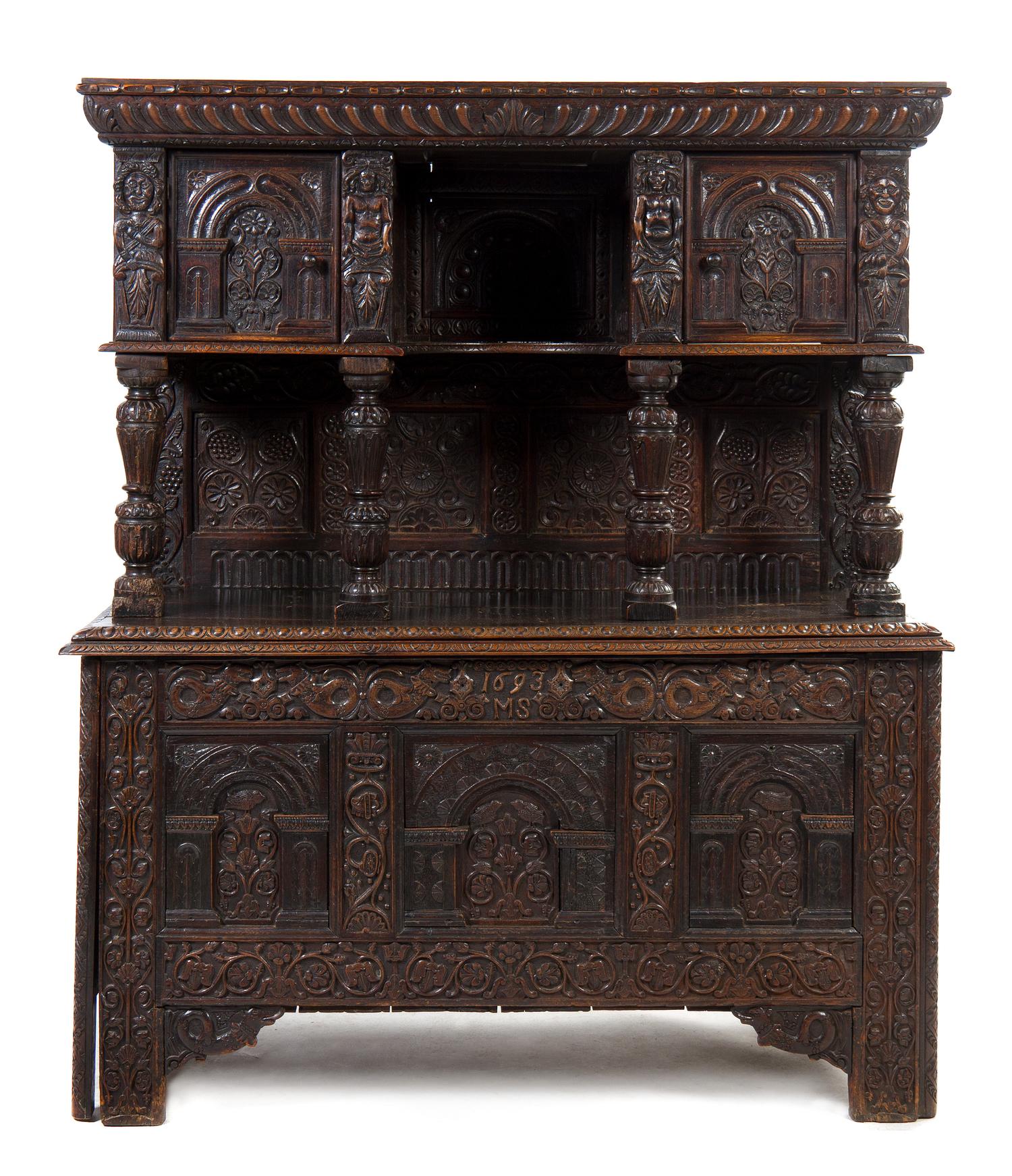 A Elizabethan Style Carved Oak Court Cupboard, Height 69 3/4 x width 58 1/2 x depth 24 1/4 inches.