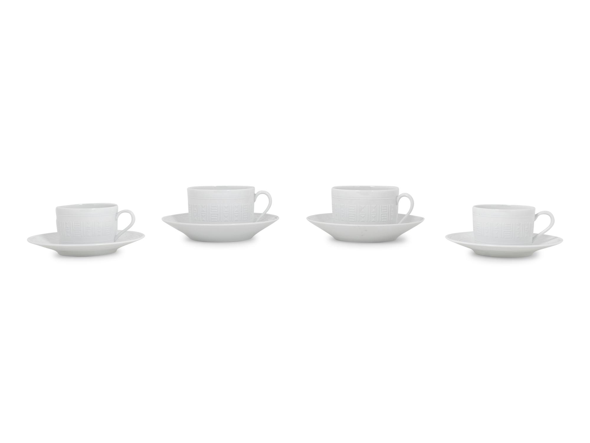 A Group of Hermès Egée Porcelain Cups and Saucers