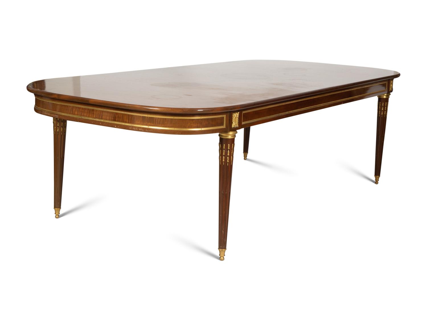 A Louis XVI Style Gilt Bronze Mounted Mahogany Dining Table