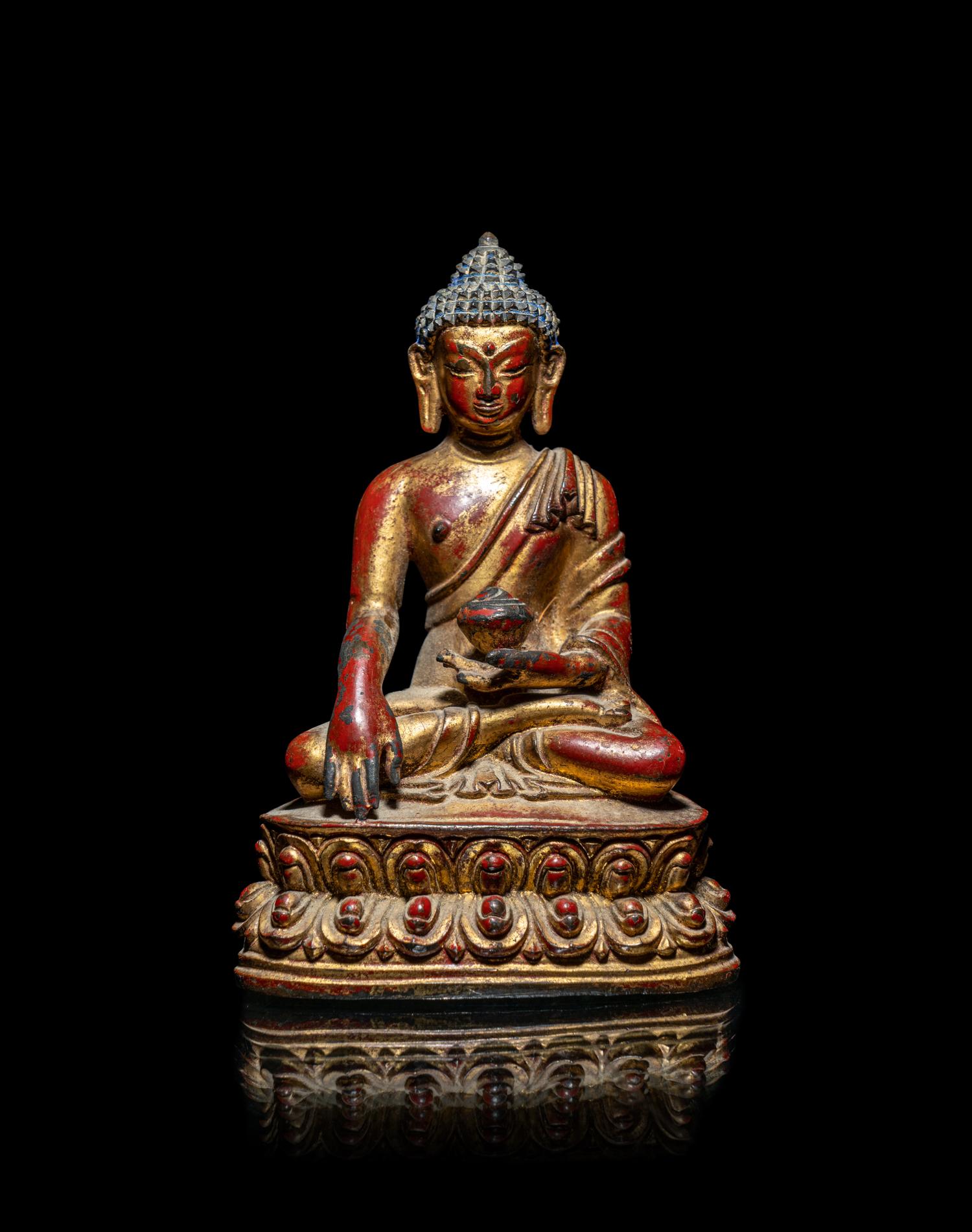 A Tibetan/Nepalese Gilt and Red Lacquered Bronze Figure of Buddha
