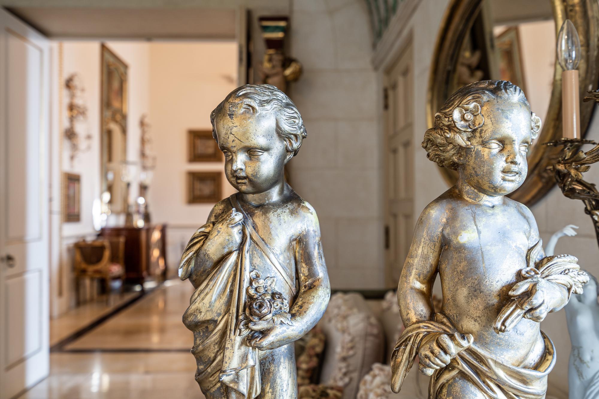 A Pair of Continental Giltwood Figures of Putti