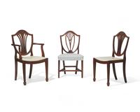 An assembled group of ten George III shield-back carved mahogany dining chairs, 18th / 19th century
