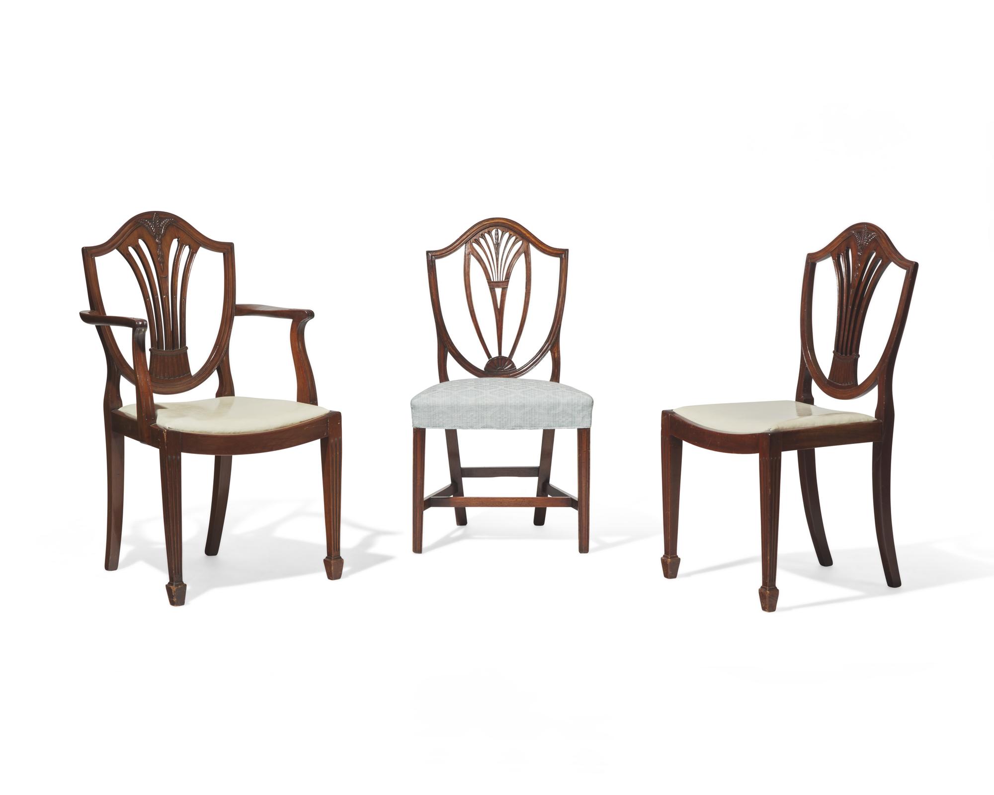 An assembled group of ten George III shield-back carved mahogany dining chairs, 18th / 19th century