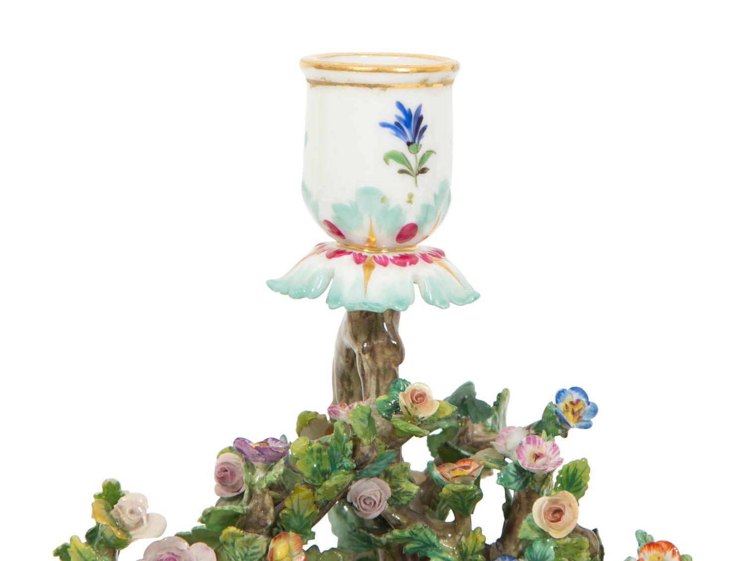 A Pair of Meissen Porcelain Figural Candlesticks with Floral Arbors