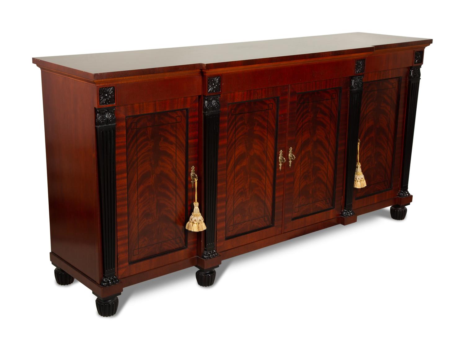 A Late Regency Style Figured Mahogany Sideboard with Carved Ebonized Pilasters