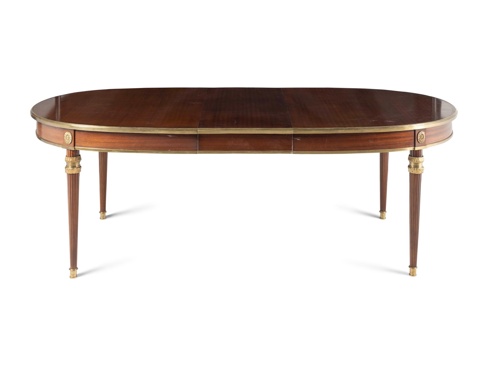 A Louis XVI Style Gilt Bronze Mounted Mahogany Dining Table