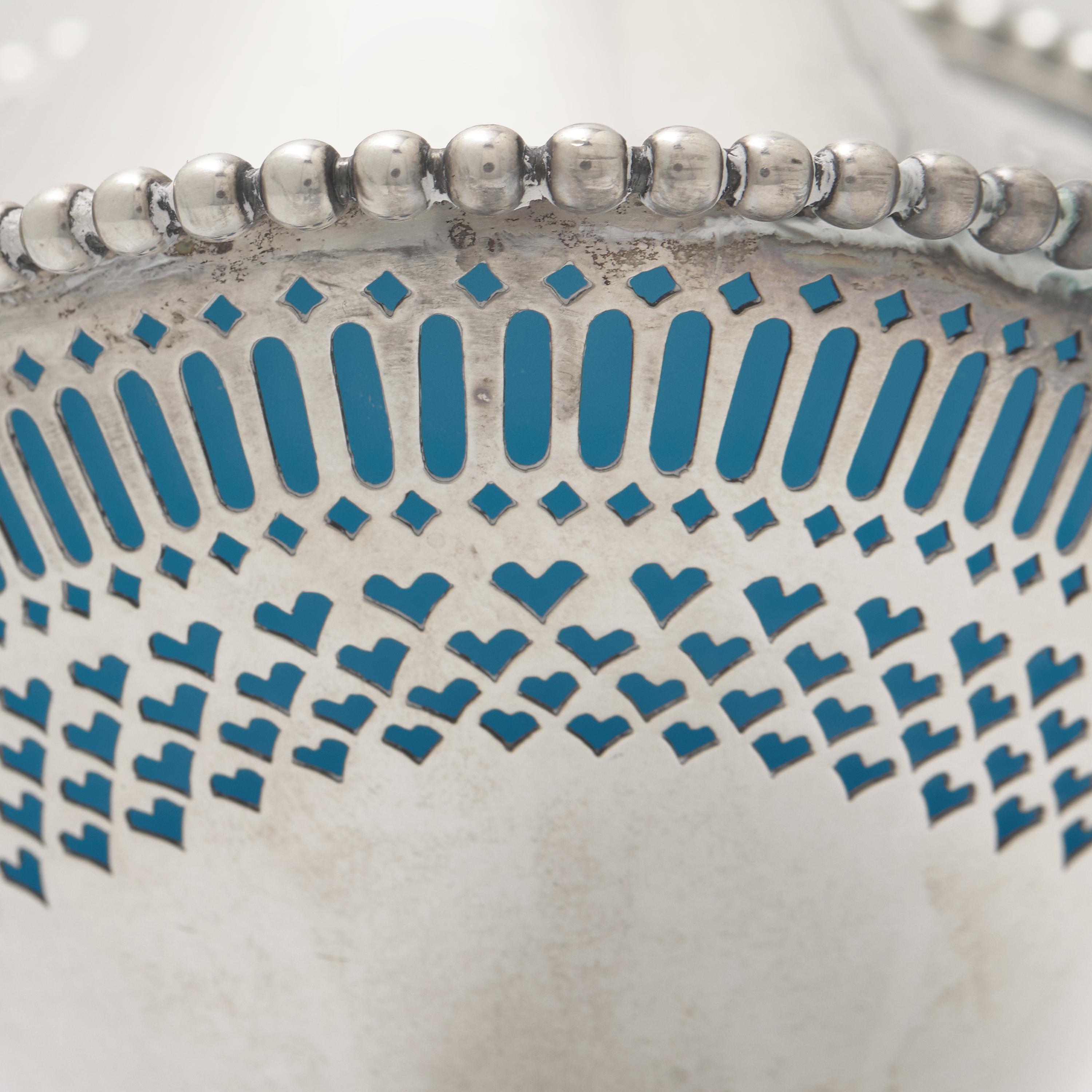 An Engraved and Pierced Coin Silver Glass-Lined Sugar Basket