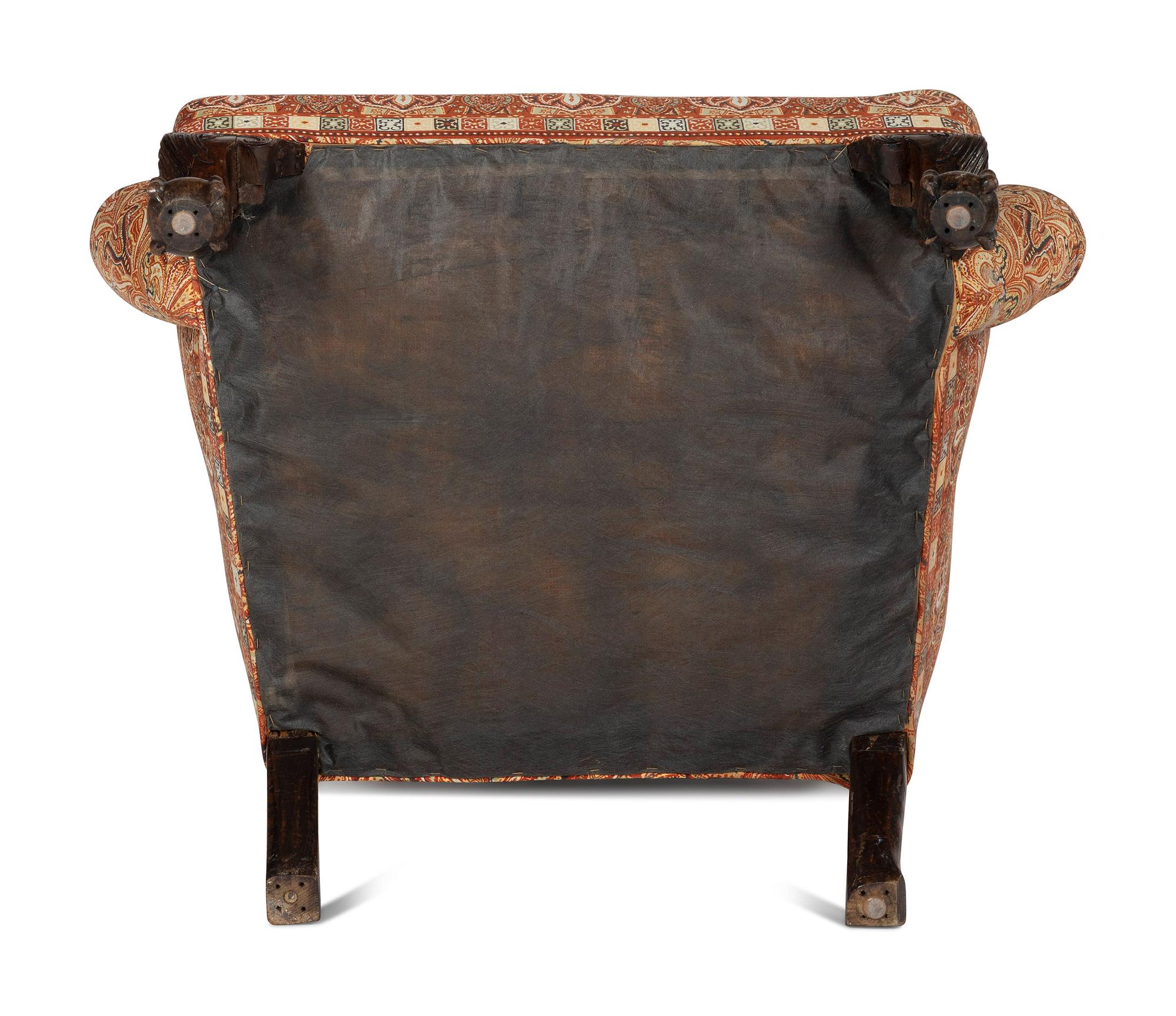 A George III Carved Walnut Claw-and-Ball Foot Easy Chair