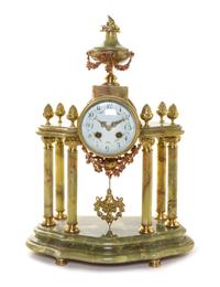 A French Onyx and Gilt Metal Mantel Clock, Height 18 1/2 inches.