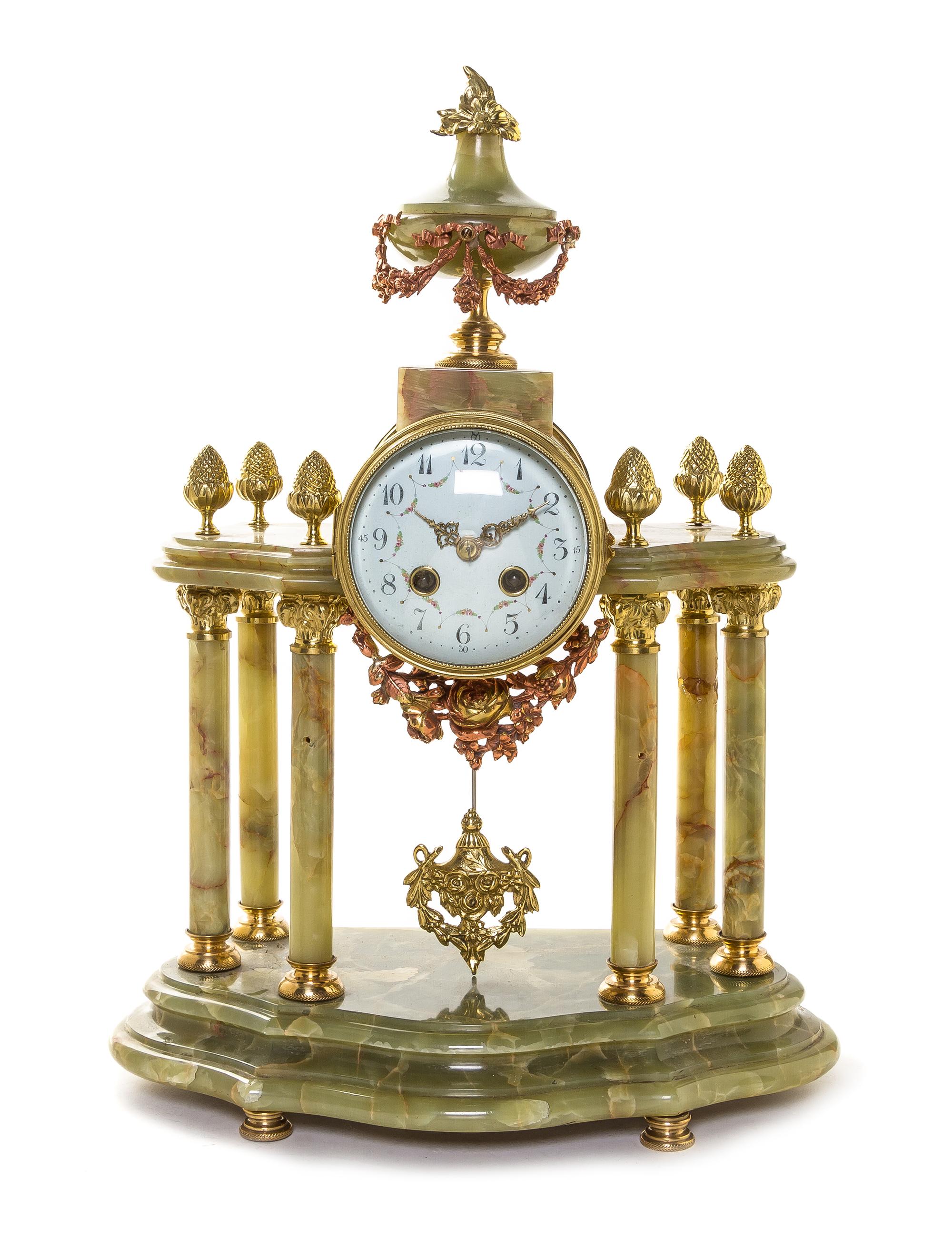 A French Onyx and Gilt Metal Mantel Clock, Height 18 1/2 inches.