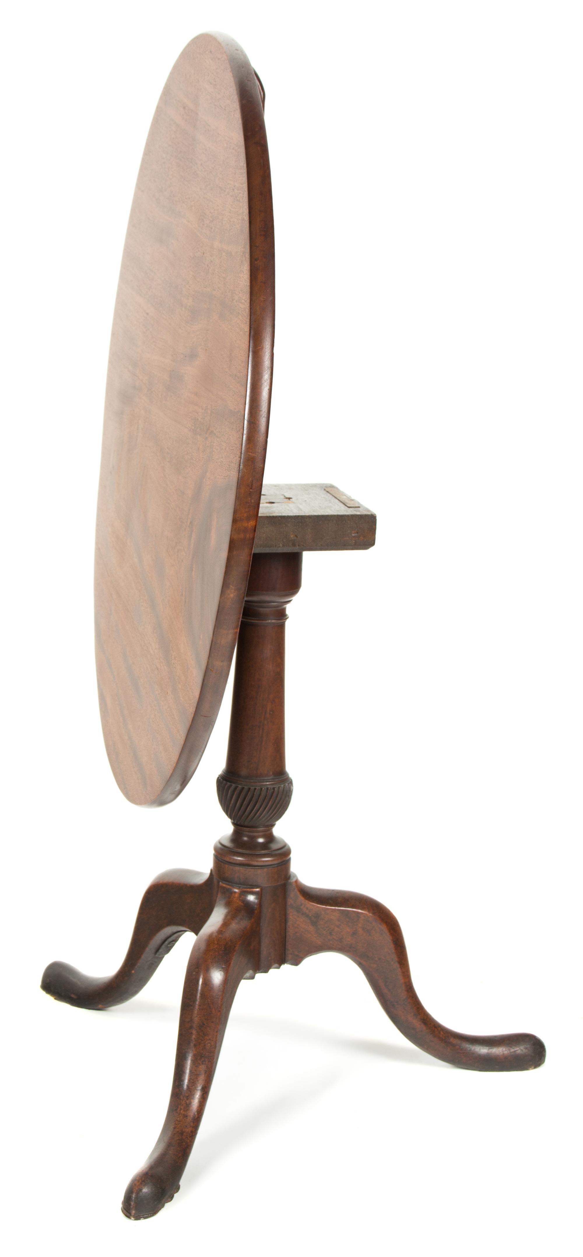 A George II Style Mahogany Tilt-Top Table Height 27 x diameter 32 inches. — 20TH CENTURY