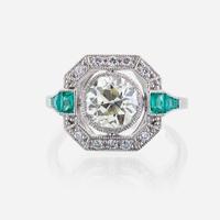 A diamond, emerald, and platinum ring