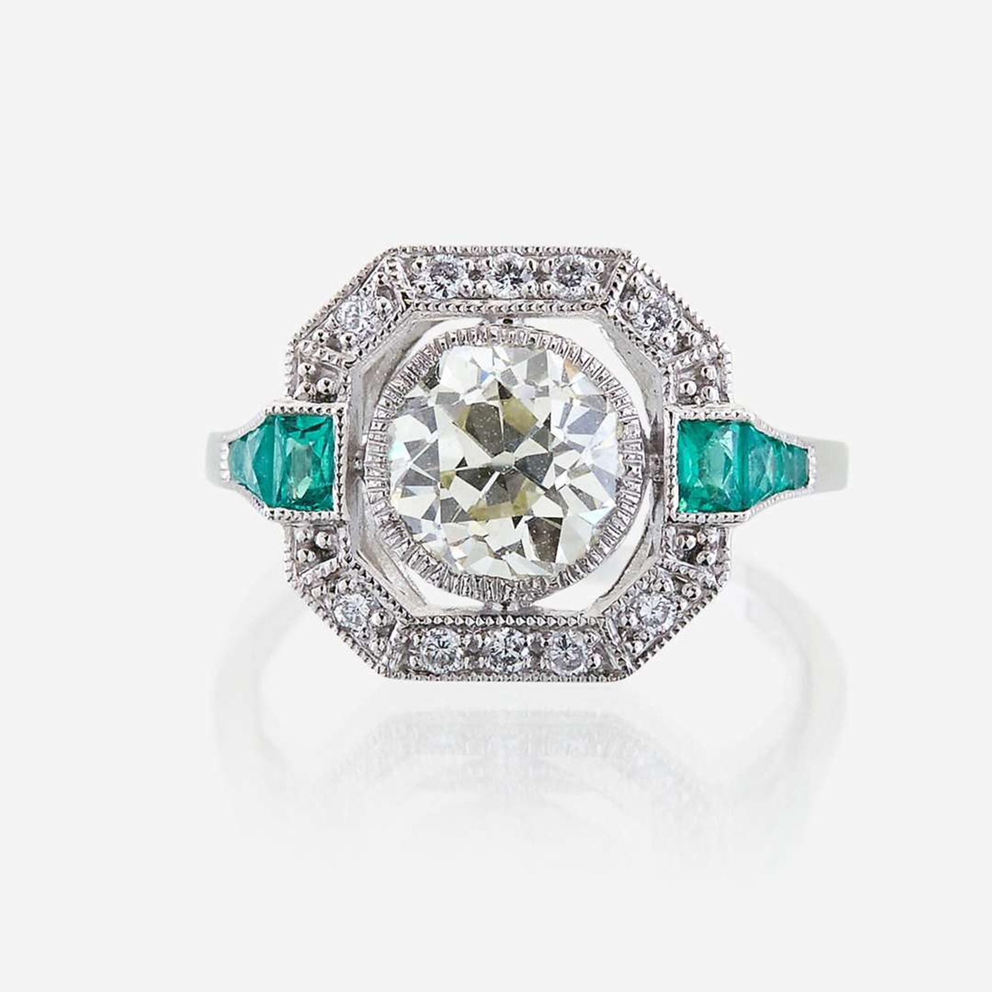 A diamond, emerald, and platinum ring