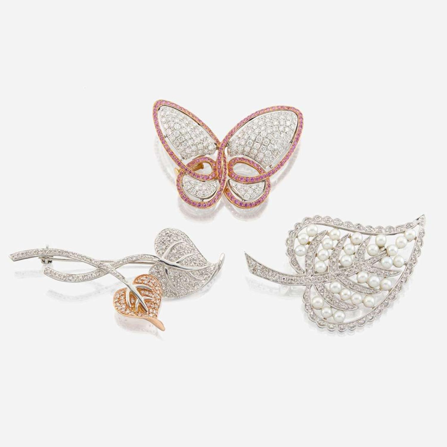 A collection of three gold and gem-set brooches