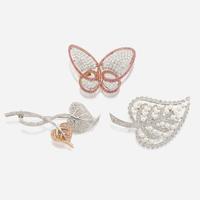 A collection of three gold and gem-set brooches