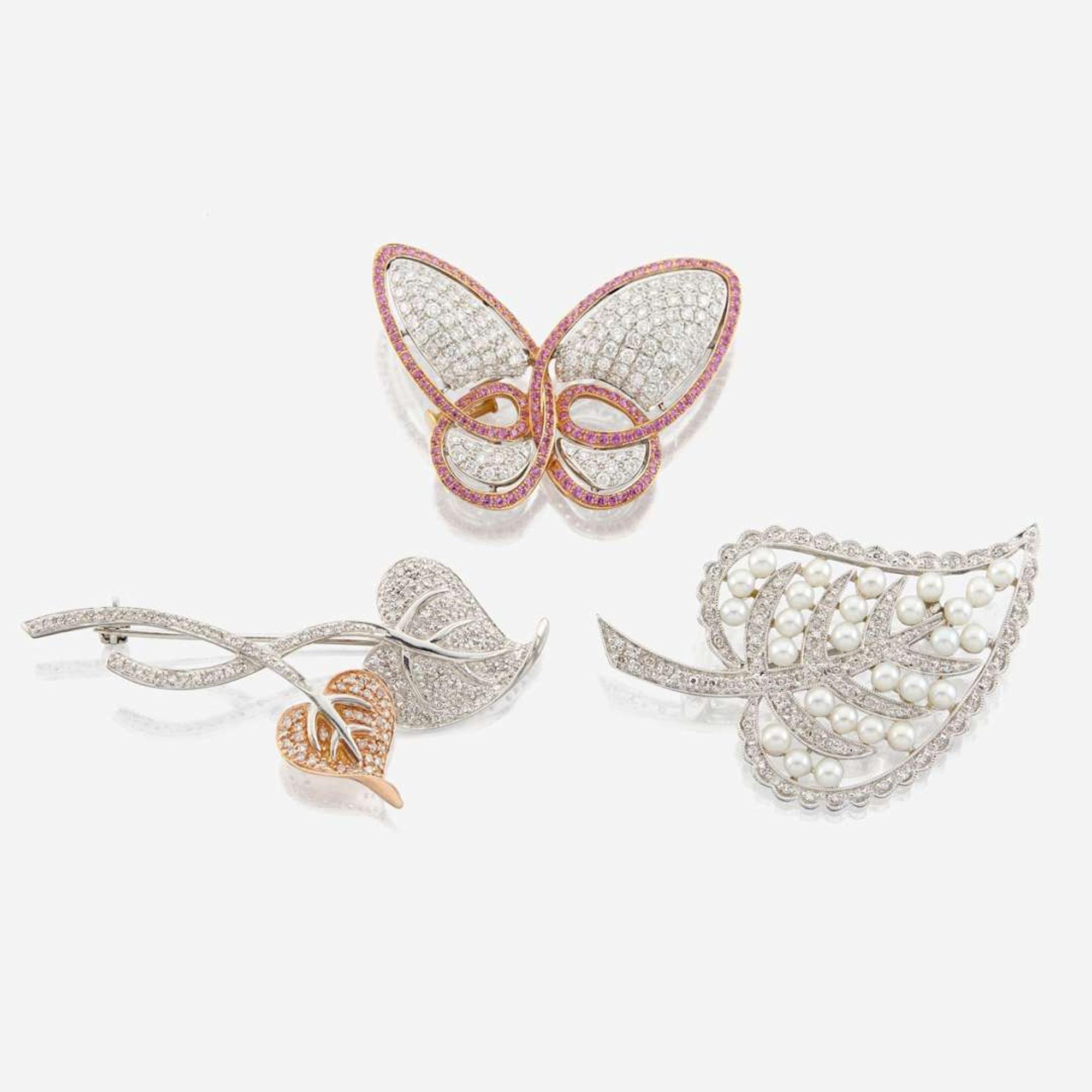 A collection of three gold and gem-set brooches