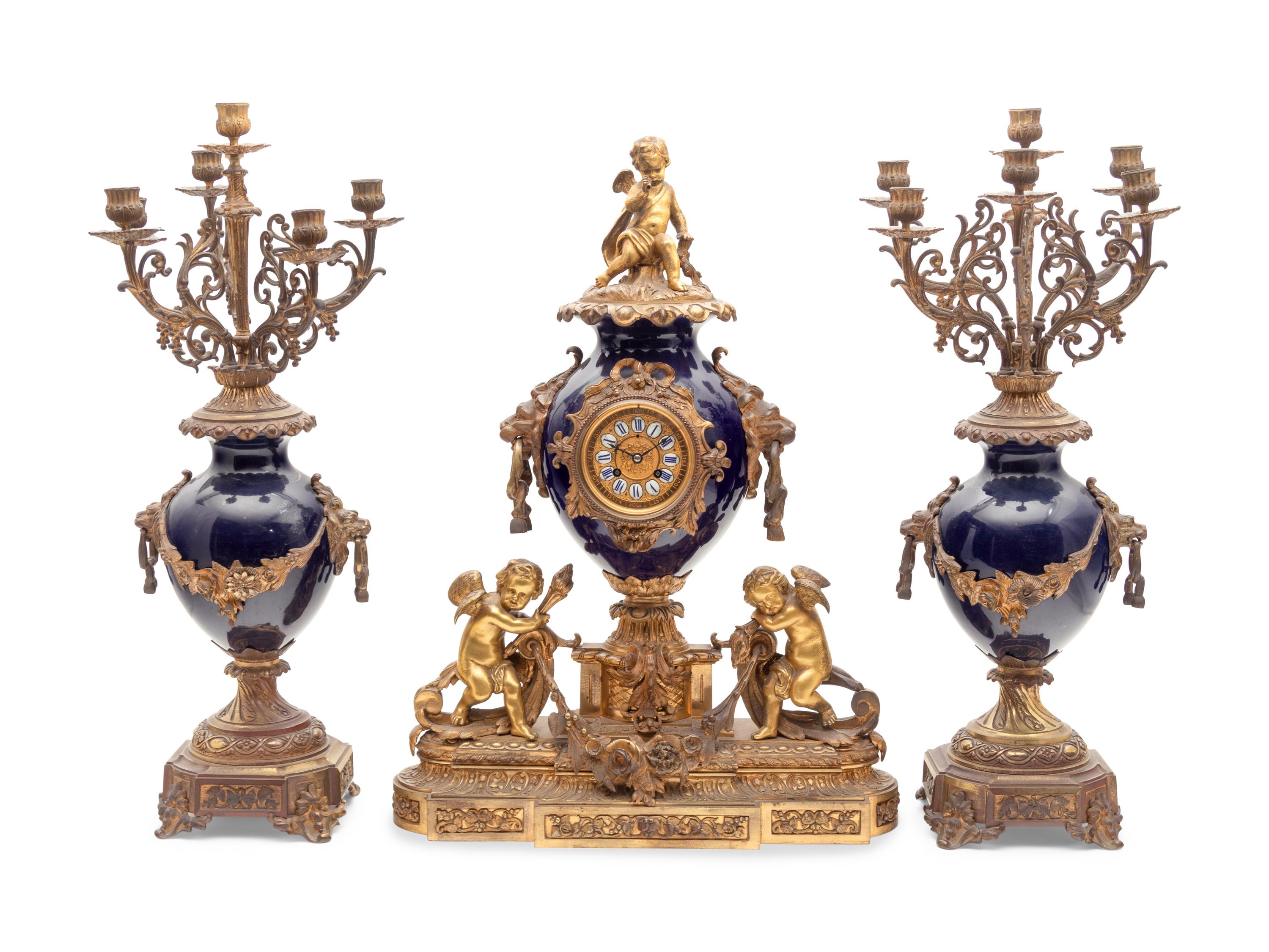 A French Gilt Bronze and Porcelain Clock Garniture