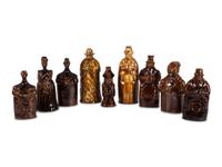 Nine Figural Flasks in Brown Glaze
