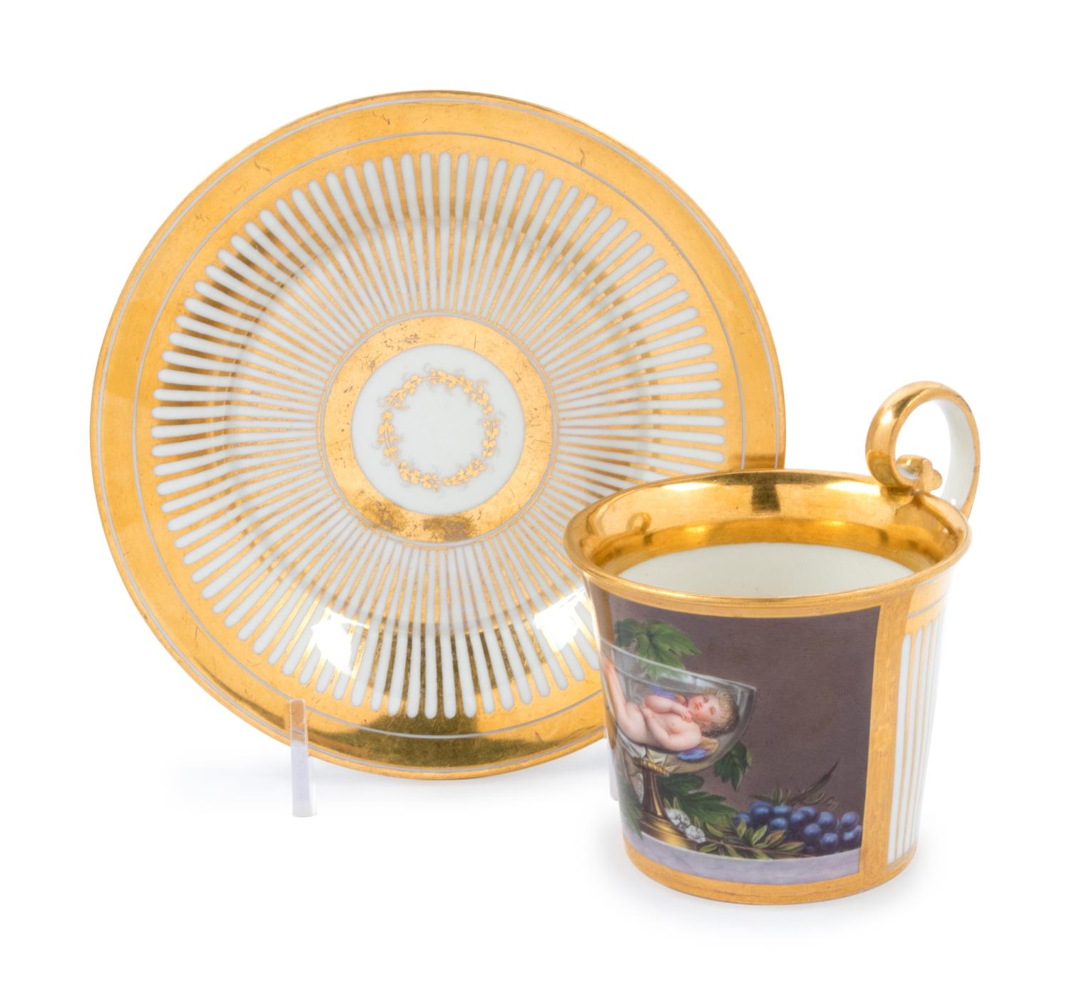 A Vienna Painted and Parcel Gilt Porcelain Teacup and Saucer