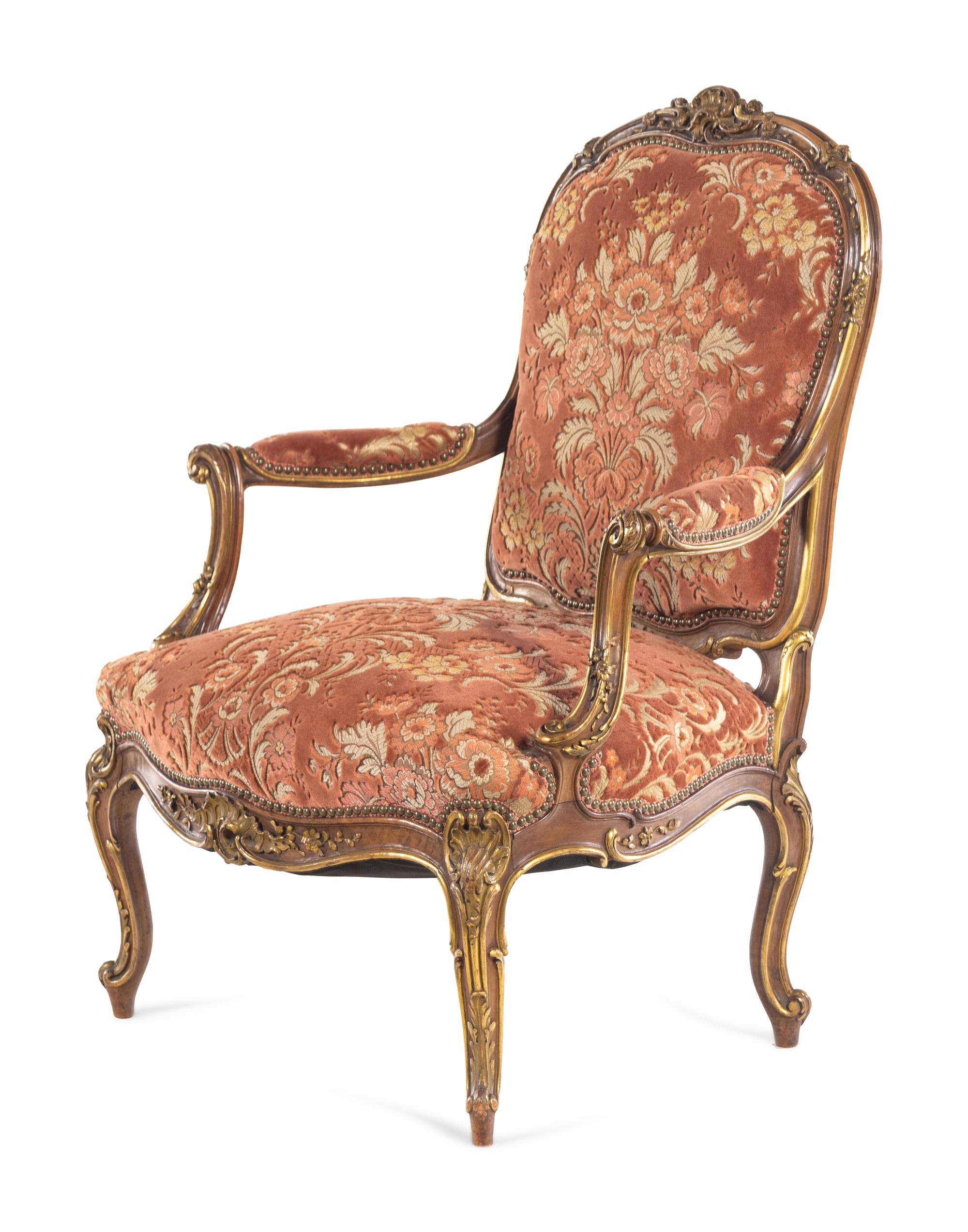 A Louis XV Style Carved and Parcel Gilt Walnut Fauteuil