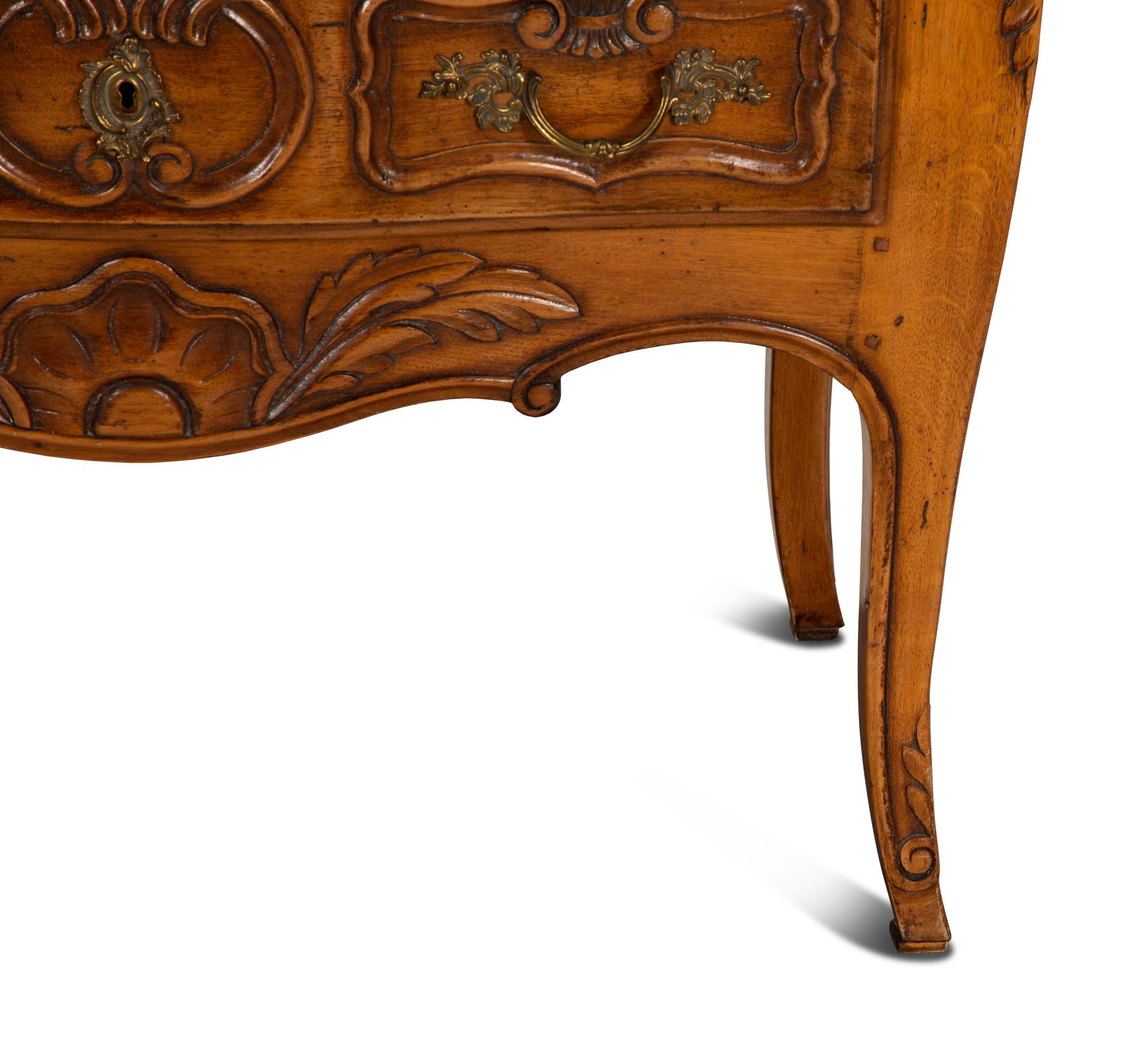 A Louis XV Provincial Style Carved Walnut Commode