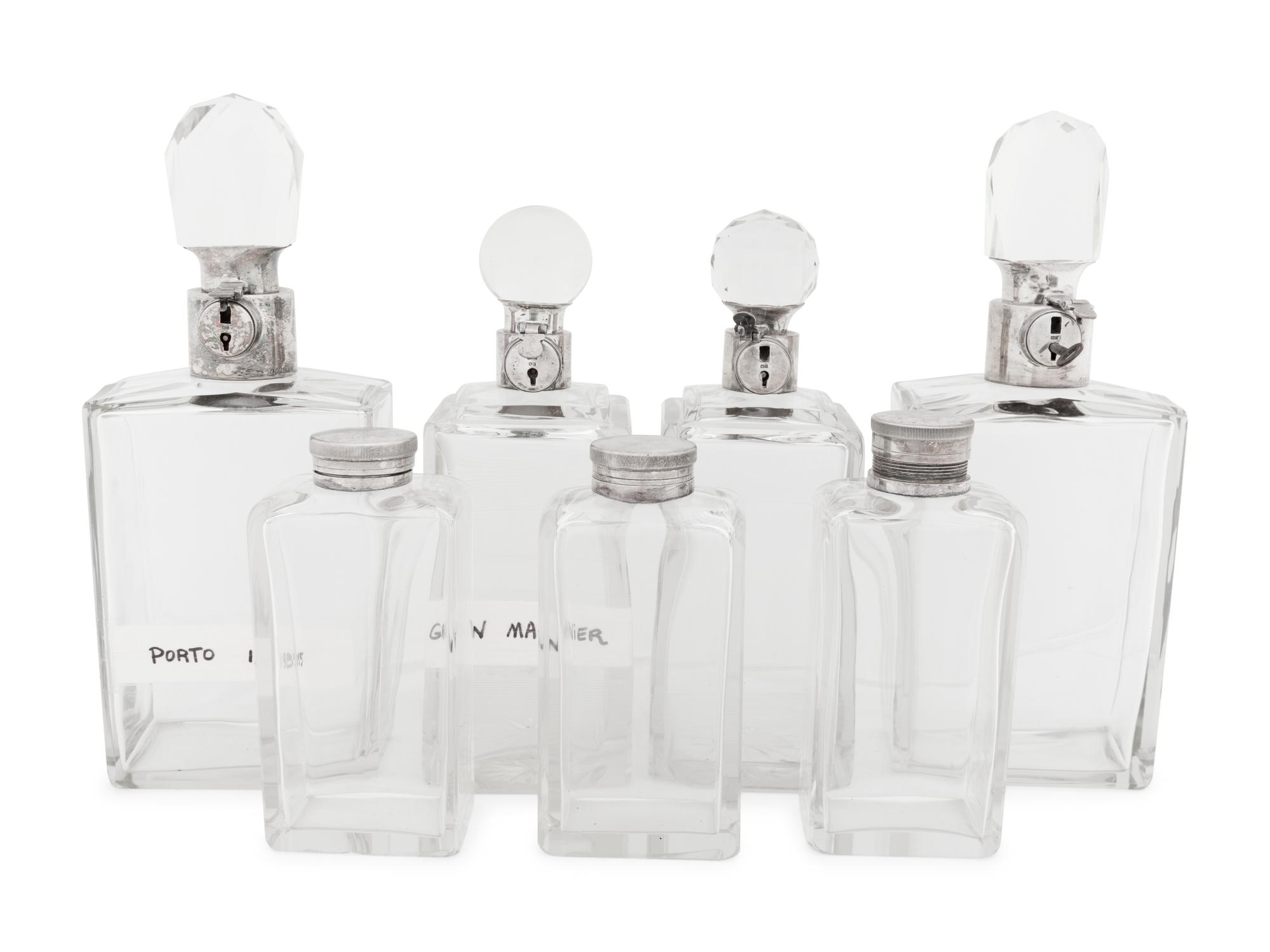 Seven Silver and Silver-Plate Mounted Glass Decanters