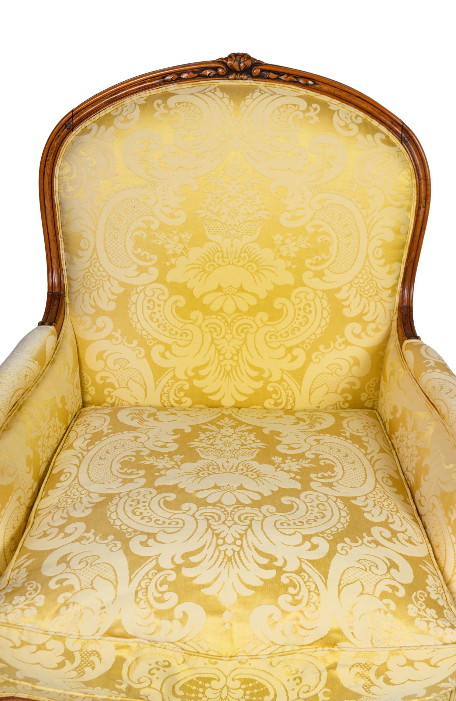 A Louis XV Style Carved Beechwood Bergère and Ottoman