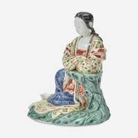 A Chinese enameled Dehua porcelain figure of Guanyin seated 18th Century, later decorated