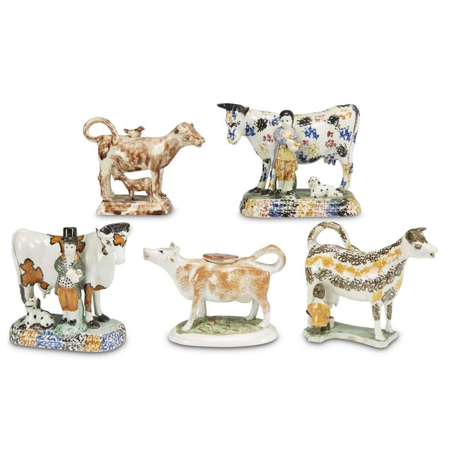 Assembled group of five pearlware and Prattware cow figures and creamers England, late 18th/early 19th century