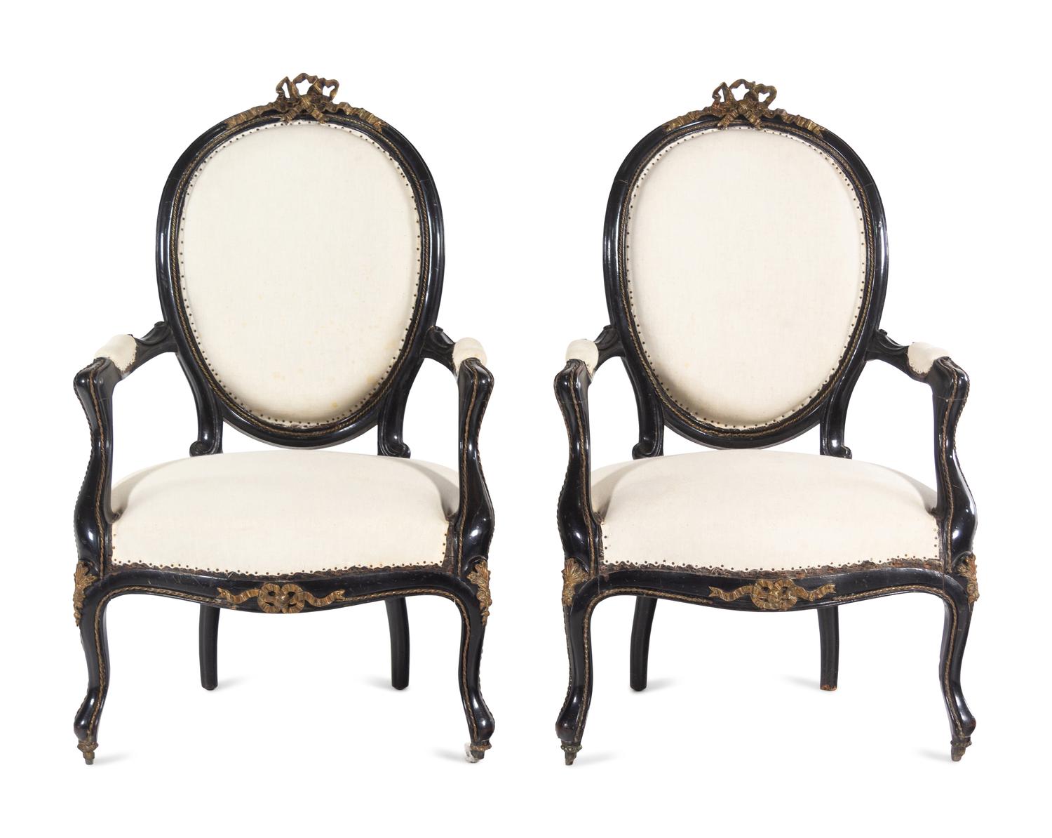 A Pair of Napoleon III Gilt Metal Mounted Ebonized Fauteuils