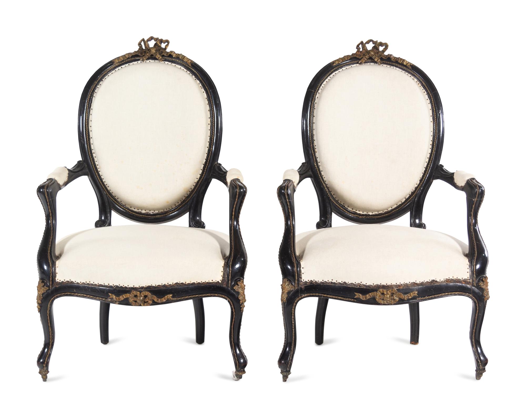 A Pair of Napoleon III Gilt Metal Mounted Ebonized Fauteuils