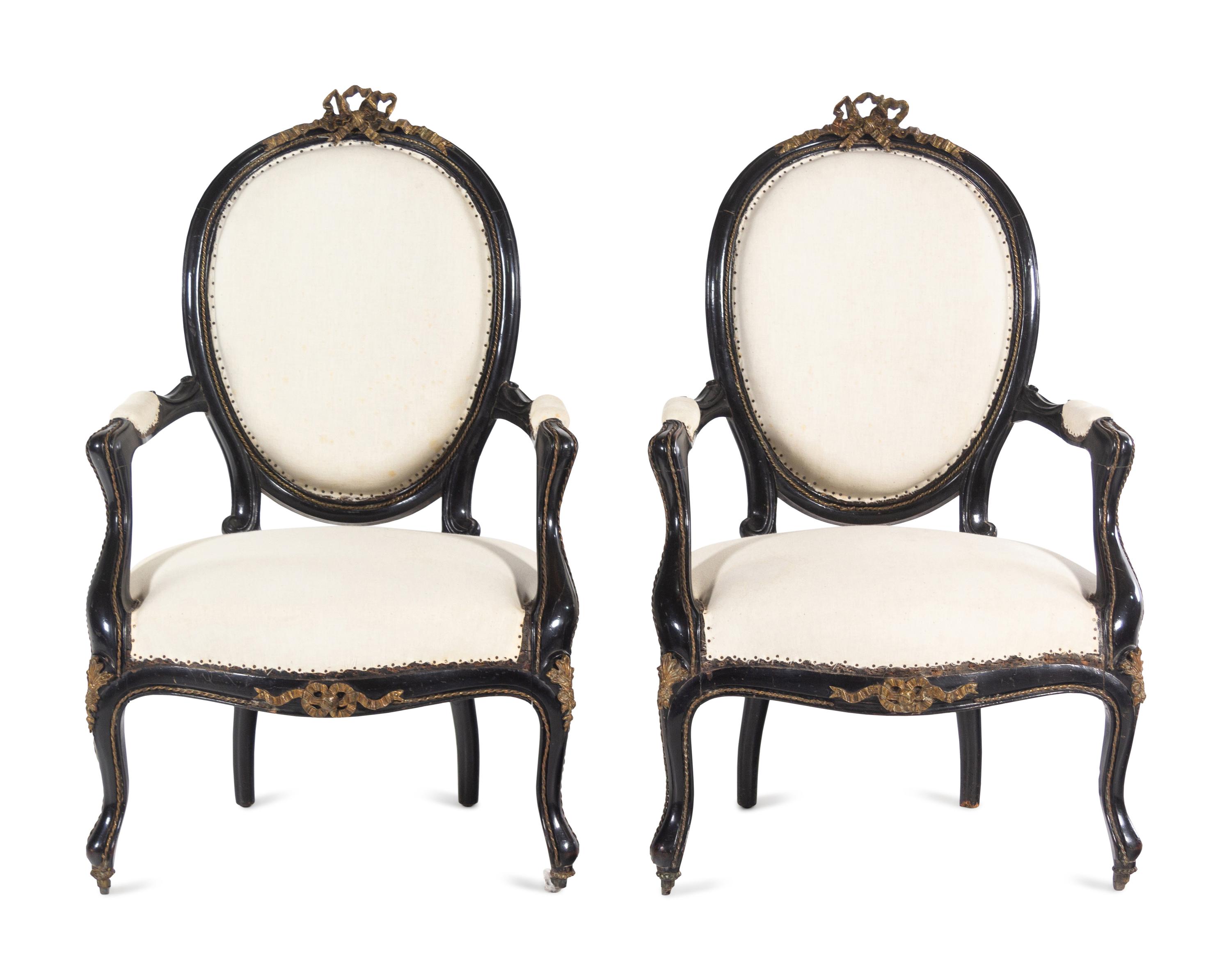 A Pair of Napoleon III Gilt Metal Mounted Ebonized Fauteuils