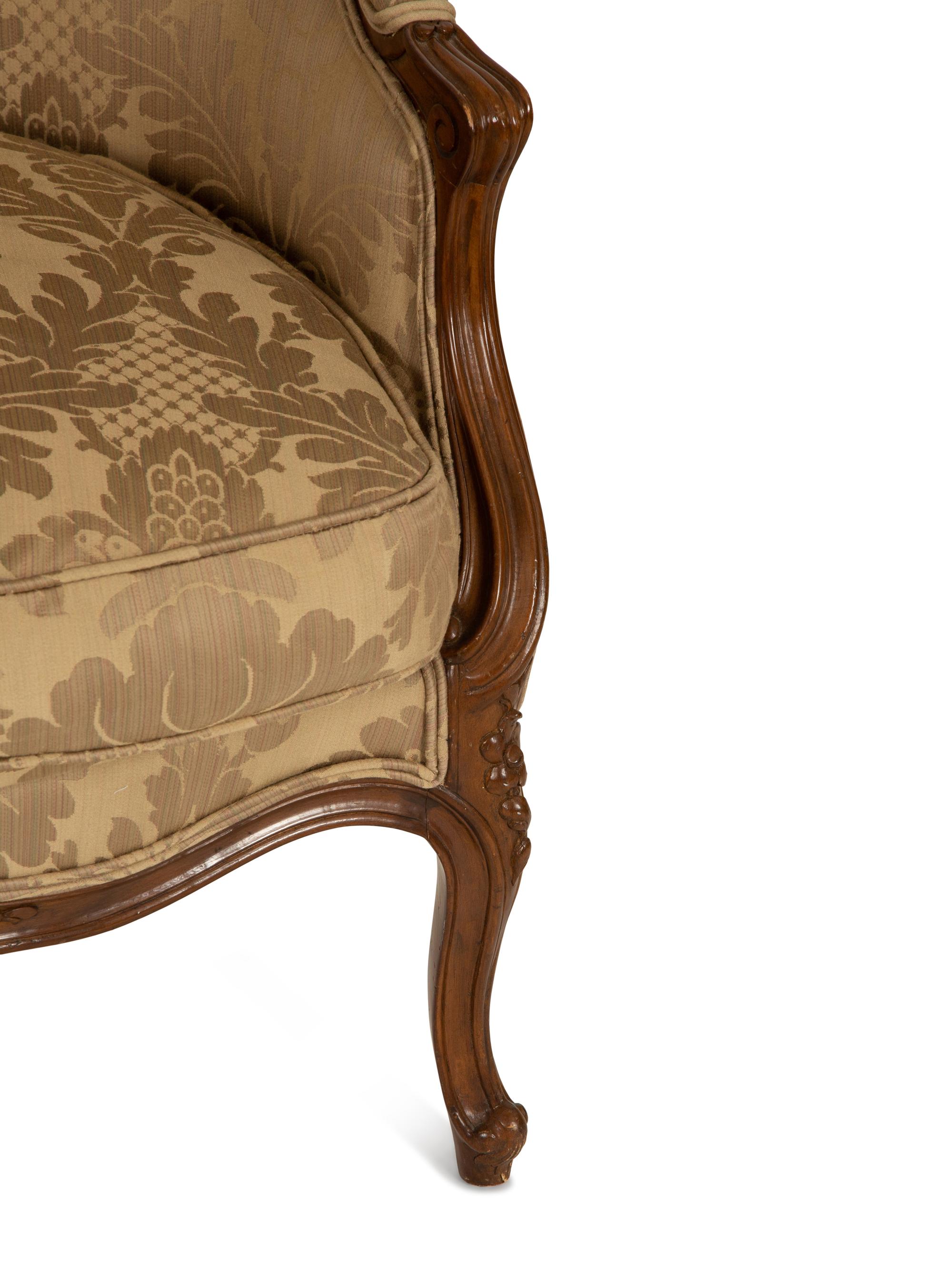 A Louis XV Style Carved Walnut Bergère
