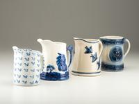 Four Cobalt Decorated Molded Stoneware Pitchers