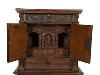 An Italian Carved Walnut Cabinet on Stand
