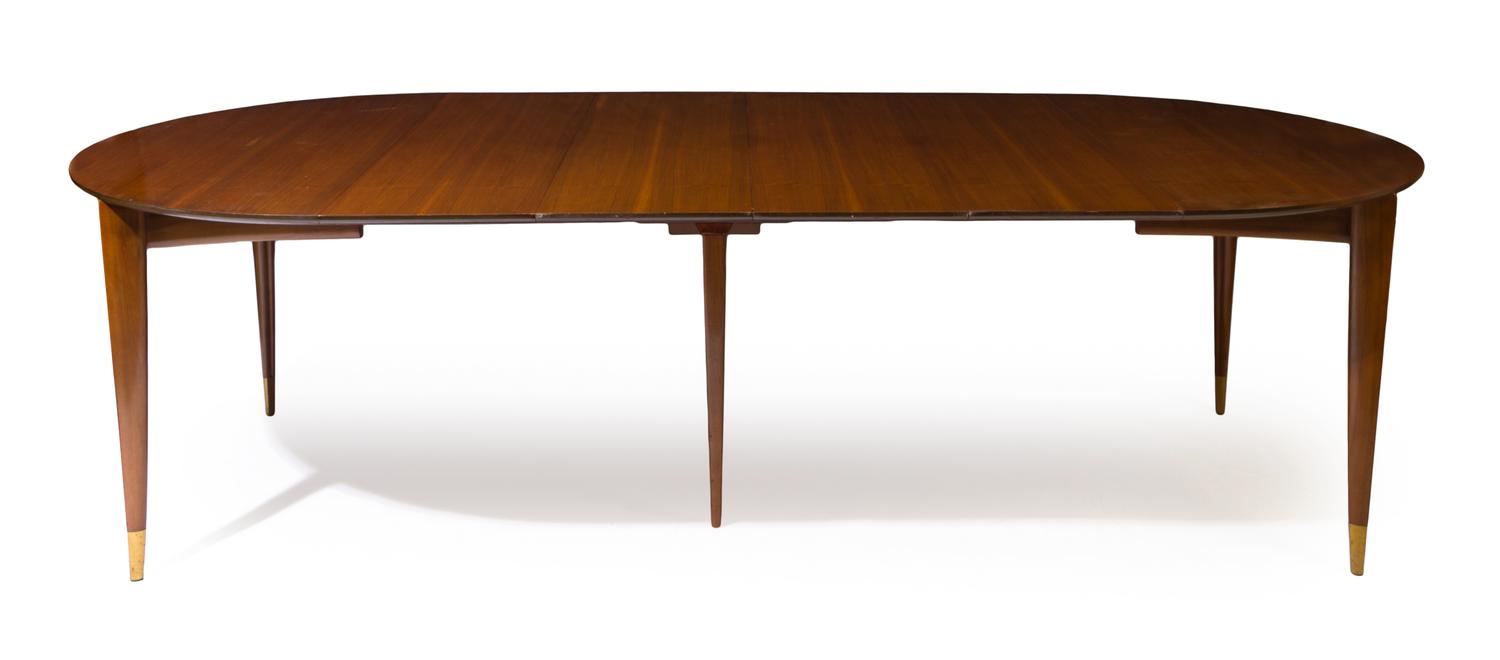 An Italian Walnut Extension Table, Gio Ponti for M. Singer & Sons Height 29 x width 48 x length 104 inches (fully extended). — CIRCA 1955