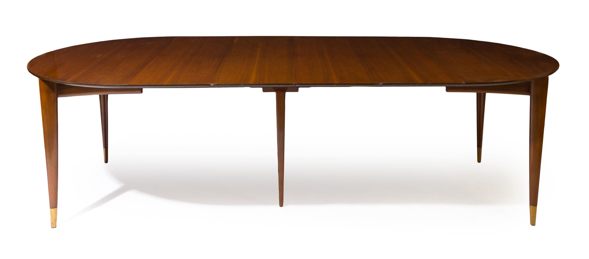 An Italian Walnut Extension Table, Gio Ponti for M. Singer & Sons Height 29 x width 48 x length 104 inches (fully extended). — CIRCA 1955