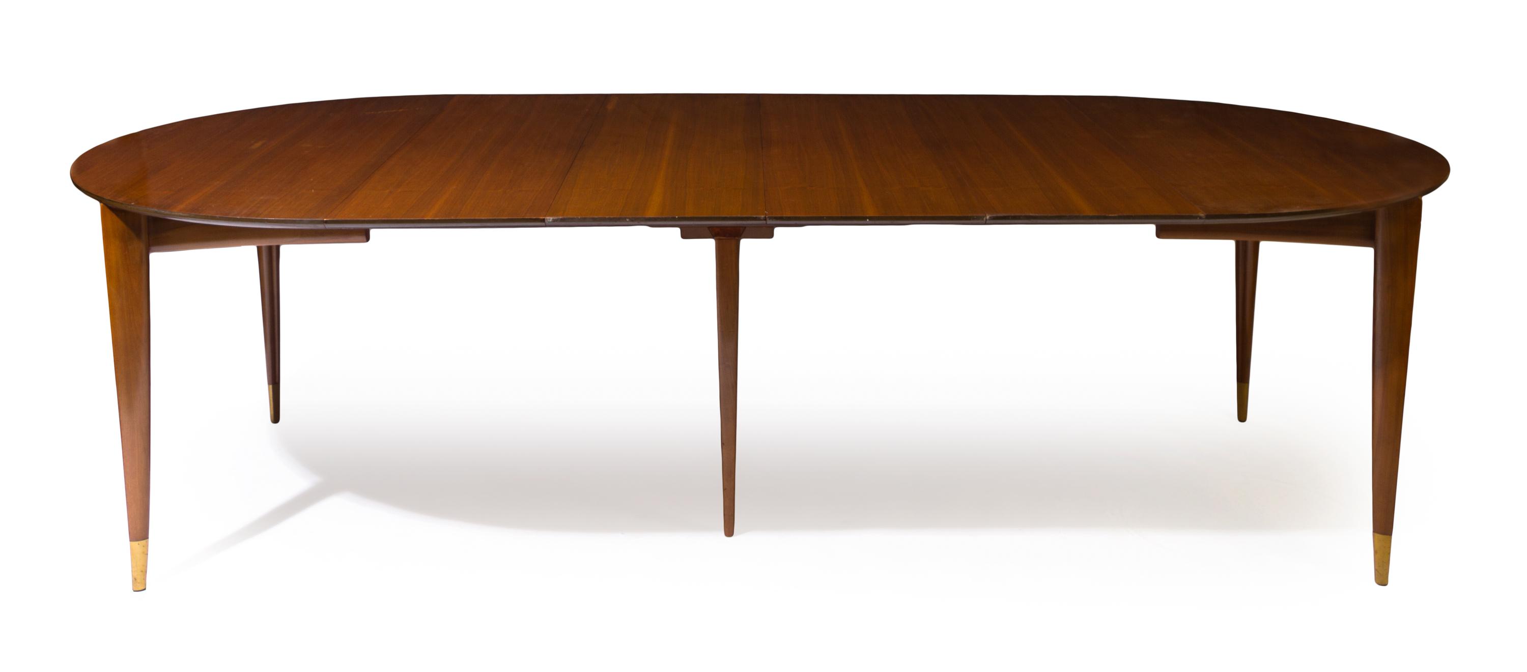 An Italian Walnut Extension Table, Gio Ponti for M. Singer & Sons Height 29 x width 48 x length 104 inches (fully extended). — CIRCA 1955