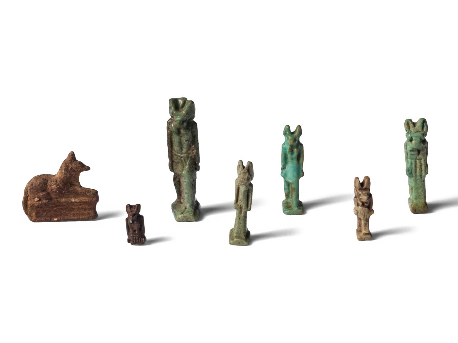 Seven Egyptian Faience and Stone Anubis Amulets