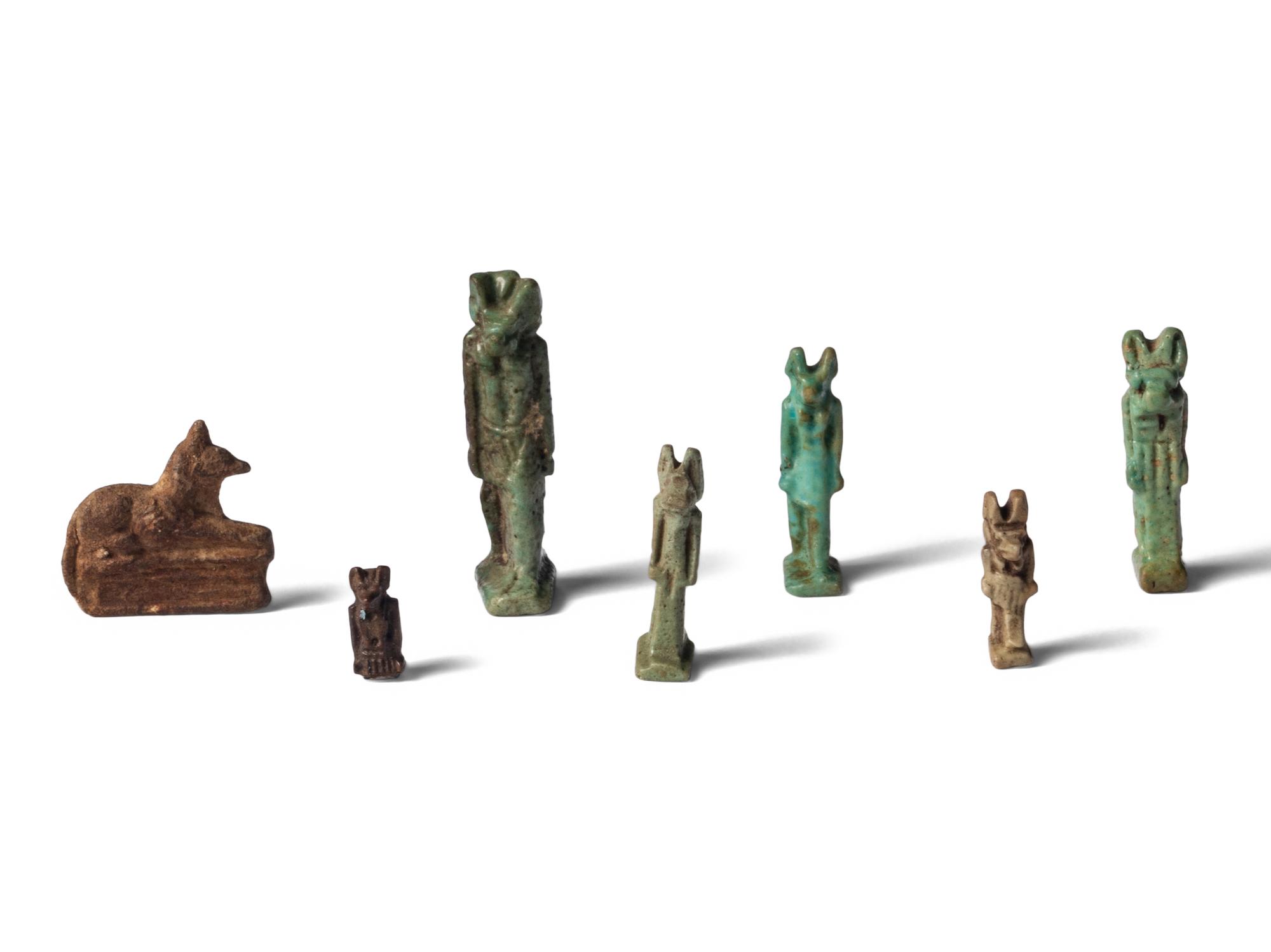 Seven Egyptian Faience and Stone Anubis Amulets